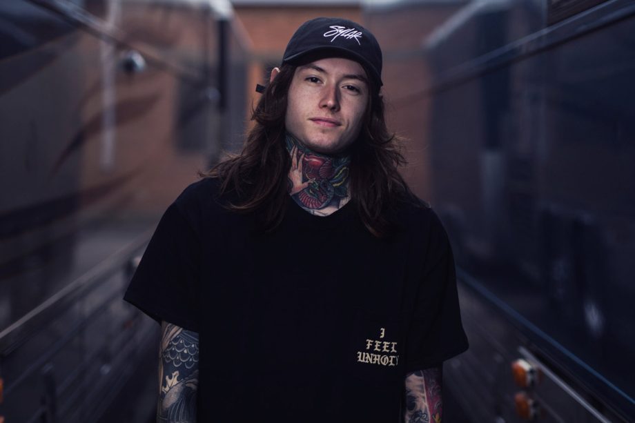 noah sebastian of bad omens photoshoot by bryan kirks wearing black tshirt and cap 920x613 1 - GeorgeNotFound Merch